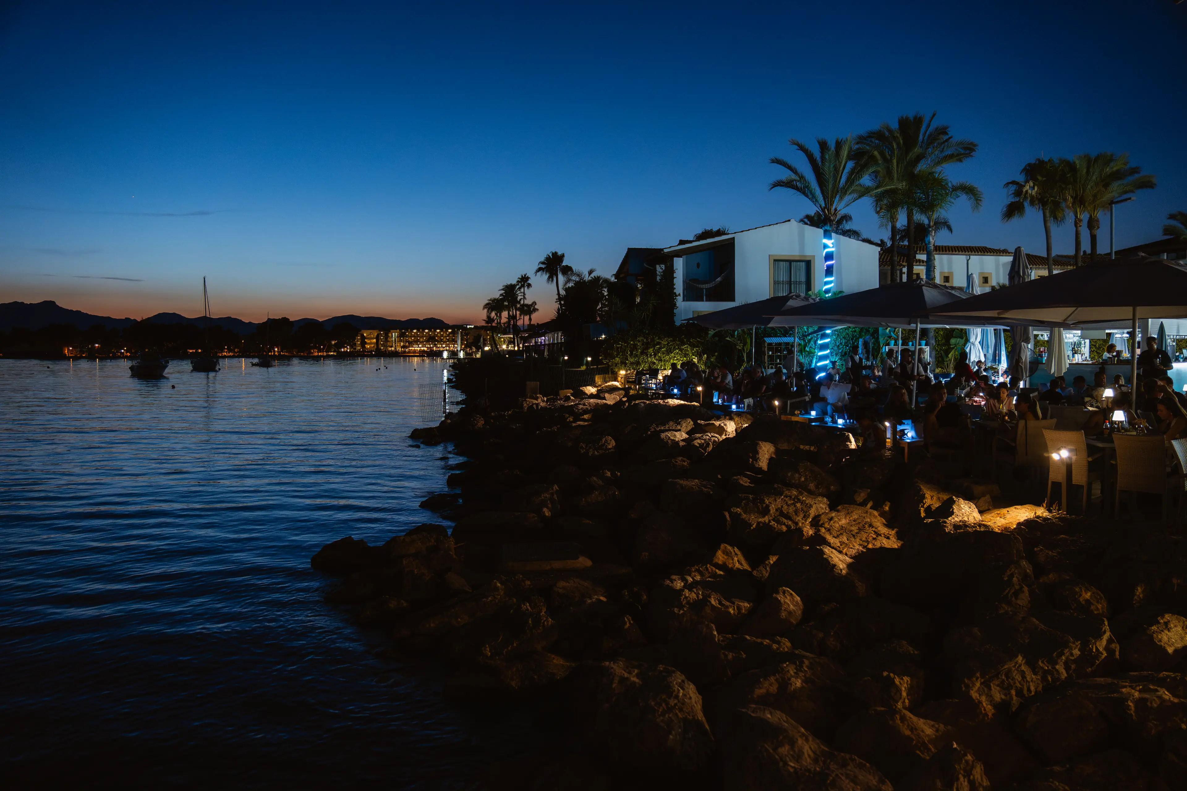 Guests enjoying snacks and cocktails at AQUA Terrace